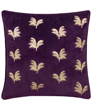 Transform your living space with the Guilded Palms Embroidered Cushion, the perfect blend of elegance and comfort. This opulent cushion boasts a luxuriously soft velvet base adorned with intricate metallic embroidery depicting serene palm leaves. The rich texture of the velvet combines with the shimmering embroidery to create a striking balance of modern sophistication and timeless charm. Designed for those who value understated luxury and meticulous attention to detail, this cushion will effortlessly elevate any space into a haven of style and relaxation. Add an unmistakably refined finish to a sofa, armchair or bed, and indulge in its inviting presence.