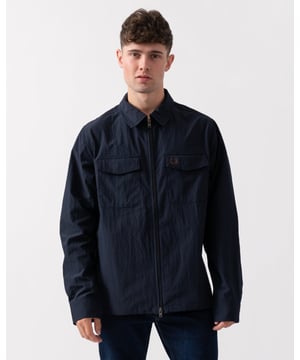 A new one for the collection, always synonymous with Fred Perry. An overlayer for colder nights and walks home after dark. The perfect layering piece for the next night out.
Somewhere between a shirt and a jacket, overshirts make for a reliable, versatile all-rounder that take you from out of the house to out for the night. Made from a lightweight polyester and recycled nylon blend to give a soft, crinkle-effect hand feel. Designed with utility-style details for a tougher look, this one offers patch pockets and a zip-through fastening with a branded puller. 60% Polyester / 40% Recycled Polyamide
M5684
 
