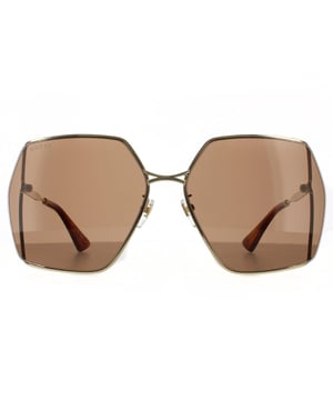 Gafas de sol cuadradas para mujer Gucci en oro y marrón. Las gafas Gucci son un diseño ligero y minimalista de gran tamaño con un armazón de metal. Una de las lentes grandes presenta un logotipo GG interlocking de metal y las varillas delgadas están grabadas con el logo de Gucci.
