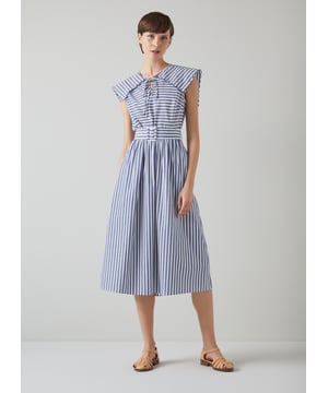 A chic sun dress which takes design cues from sailor style, beautiful Beau is destined for glamorous destinations. It's crafted from blue and cream striped cool cotton, and has a wide scalloped edge collar with tie detail, a fabric-covered buckle belt and an A-line midi skirt. Wear it with a pair of leather sandals and a basket bag.