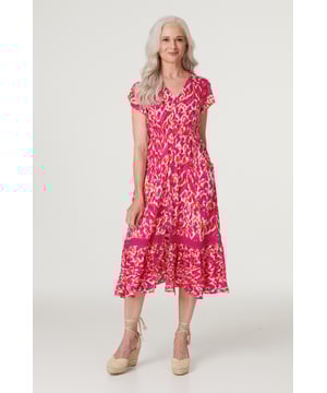 Add a statement maxi dress to your closet with this vibrant printed a-line dress. With a V-neck, a button front, frilled cap sleeves, pockets and a crochet detail tiered midi skirt. Style with blush heels and a clutch bag for a garden wedding or dress down on holiday with sandals.