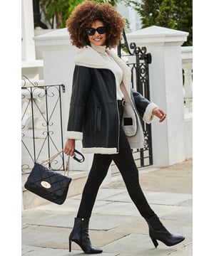 Stay warm in style So luxe you won't believe it's faux leather It's got the softest faux shearling lining Cut for a cool and comfy relaxed fit Finished with pockets and statement turn up cuffs Throw over jeans and a jumper or a gorgeous dress