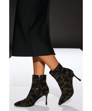 Striking camo pattern with glittering diamante accents
        Sleek pointed toe design for a sophisticated silhouette
        Ankle-length style with convenient side zip closure
        High heel measuring between 7 and 9cm for added height
        Versatile faux leather construction for day-to-night wear
    
    Step into style with these eye-catching Runway Camo Diamante Pointed Ankle Boots. The unique combination of a bold camo pattern and sparkling diamante details creates a captivating look that's sure to turn heads. Perfect for those seeking to make a statement, these boots effortlessly transition from day to night. Pair them with a sleek black midi dress for a runway-inspired ensemble, or style them with distressed jeans and a leather jacket for an edgy street look. The pointed toe and high heel add a touch of elegance, making these boots suitable for both casual outings and more formal occasions. Whether you're heading to the office or out for dinner, these versatile ankle boots will keep you looking chic and feeling confident.