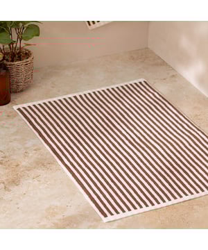 Elevate your bathroom with the Hebden Striped Cotton Bath Mat, crafted from 100% cotton terry for an irresistibly soft feel underfoot. Combining a timeless striped design with versatile contemporary shades, it brings a perfect balance of classic and modern style to your space. Designed to create a cool, calming atmosphere, this bath mat promises more than just style—it enhances your sense of comfort and wellbeing. Durable and naturally breathable, it offers practicality to match its beauty, making it an essential finishing touch to your home environment.