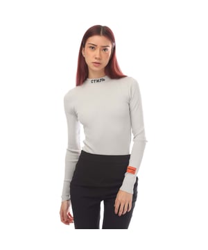 Womens Heron Preston CTNMB Long Sleeve Knitted Bodysuit in light blue.- Turtle neck.- Long sleeves.- Embroidered logo at neck and sleeves.- Orange logo patch sewn at sleeve.- Knitted  lightweight knit.- 72% Viscose  28% Polyester.- Ref: HWHP001F214001