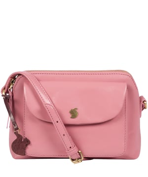 The 'Dainty' cross body bag from Conkca is crafted from leather that has a beautifully smooth finish. A zip-over top conceals the spacious central compartment which comes lined with natural, untreated 100% cotton lining alongside a handy slip pocket. Additional storage is proved by a magnetic press-stud secured slip pocket and comes with an adjustable slimline leather strap. Finished with rustic gold metal fittings and adorned with the iconic Conkca logo and charm.