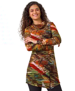 Abstract Print Cowl Neck Tunic Top from Roman. Add a pop of colour to your Autumn Winter closet with our vibrant abstract print tunic. This trendy top features a flattering roll cowl neckline and long sleeves to keep you cozy in cooler seasons. Crafted from a smooth jersey fabric, this tunic has a split hem on the side for added style, finishing at hip length for a flattering silhouette. Perfect to pair with jeggings and ankle boots for a fashionable fall look!