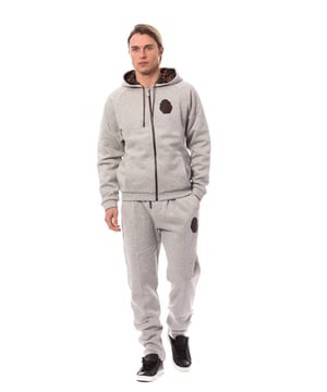 Sweatsuit with hooded sweater and elasticated pants
  Brand new with tags
  100% Authentic Billionaire Italian Couture
  Sweater features a hooded neck and two-way full zip fastening
  Long raglan sleeves and two hand pockets
  Patterned lining and string adjustable hood
  Ribbed cuffs and hem with hanger tab
  Logo patched at the left side chest hanger tab branded strings endings and zips pull tabs
  Pants with elasticated and string adjustable waist
  Two hand pockets and seam front
  Logo patched at the front near left hand pocket also branded strings endings
  Made in Italy
Material: 100% Cotton