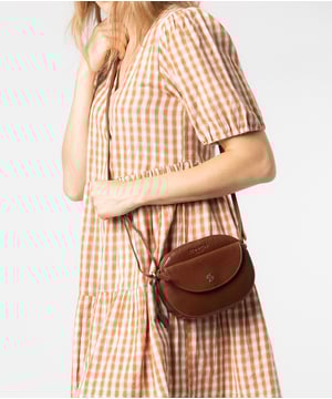 The 'Una' cross body bag from Conkca London is handcrafted from multi-toned leather for a beautiful finish. A zip-over top opens to reveal a spacious yet compact main compartment with two slip pockets, lined with natural and untreated 100% cotton. A pocket on the front secured by a magnetic press-stud and a slip pouch on the rear provide on-the-go storage. Comes with an adjustable leather strap with a maximum drop length of 68cm. Adorned with the inimitable Conkca squirrel charm and Conkca logos.
