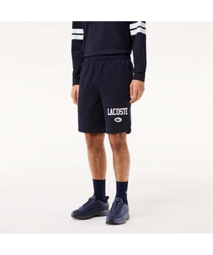 Own the french fashion sport The Joggers tracksuits : Comfort shape Regular fit  regular ease on body  hip and leg Shorts in our classic French Terry Climbing style drawcords 5cm puffed badge with silicone crocodile sewn at bottom Lacoste wording in flock print.
