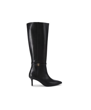 This Kurt Geiger Kensington Flexi Knee High boot features a sleek black leather upper with pointed toe. There is an antiqued brass eagle head on the slim ankle strap. The sole has added flexibility for a unique comfort. Heel height: 6.5cm.