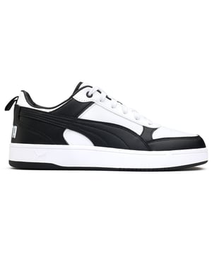 Lace Up And Power Your Stride With The Puma Dribble Court Trainers. These Retro-inspired Kicks Feature A Synthetic Leather Upper With The Iconic Puma Branding. The Padded Collar And Comfort Insole Cushion Your Every Step, While The Grippy Rubber Outsole Handles The Blacktop Like A Pro. Whether Playing A Pick-up Game Or Just Looking The Part, These Classic Black And White Trainers Have You Dribbling In Style.