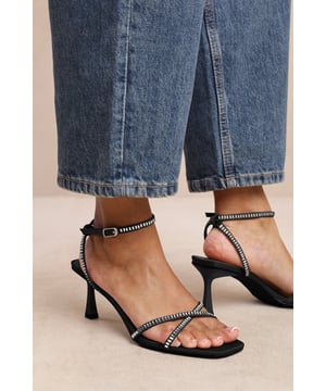 Introduce a touch of glamour to your footwear collection with our Luisa Square Toe Low Block Heel with Diamante Cross Over Strap Detail. These heels are the epitome of elegance and sophistication, making them the perfect finishing touch to any outfit, whether it's for a formal event, a night out, or a special occasion.Key Features:



Exquisite Design: The square toe silhouette of these high heels exudes a timeless appeal that never goes out of style. Enhanced by the diamante detail strap, these shoes are guaranteed to make heads turn.

High-Quality Construction: Crafted from premium materials, these high heels are designed to last. The high-quality construction ensures long-lasting durability while maintaining the comfort of your feet.


Specifications:


Closure: Ankle strap with buckle.
Heel Height: 3.3' (8.3cm) approx

Invest in our Luisa Square Toe Low Block Heel with Diamante Cross Over Strap Detail and bring that extra touch of elegance and sophistication to your wardrobe. They speak loud and clear of luxury and style – a piece worth showcasing!