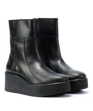 Mid-calf boot featuring a sleek leather upper with a convenient zip fastening. Durable wedge rubber sole with a 7 cm heel for added height and style.