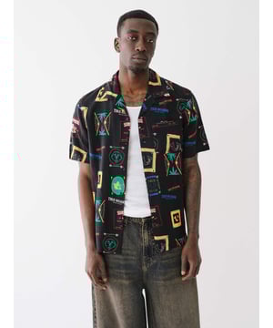 Grab your luggage and head to somewhere tropical in the Resort Print Camp Collar Shirt. Crafted from a soft woven fabrication, this men’s shirt features an allover conversational resort print, camp collar, short sleeves, and button-front closures.