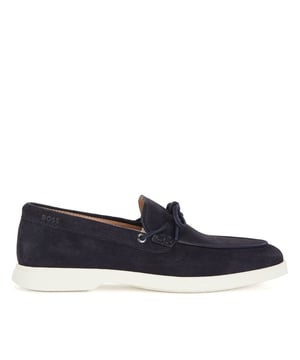 A slip on shoe with suede uppers featuring decorative tassels across the vamp in dark blue suede and all over dark blue stitch details. Two silver branded eyelets situated on the outstep and instep with the signature BOSS logo embossed on the outstep of the heel. A textured rubber midsole in off white with a branded and textured rubber undersole in off white.