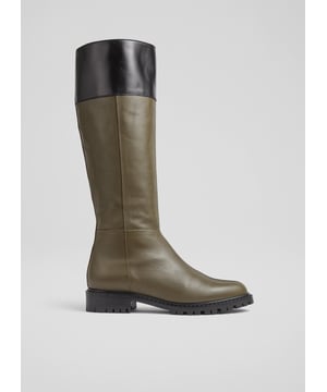 A knee-high boot with a biker feel, our Lincoln flat boots are a brand-new style in our autumn/winter collection. Crafted in Italy from super-soft army green calf leather, they have a round toe, a contrast border in black, an inside zip and a rugged, chunky flat sole. Wear them to dress down winter dresses or with jeans on more casual days.