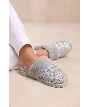 Experience ultimate comfort and cozy warmth with our Snuggle Slip On Sequin Slippers With Fur Trim. These luxurious slippers are perfect for lounging at home or keeping your feet snug during colder seasons.Key Features:



Soft Knitted Upper: The knitted upper design adds a touch of style and texture to these slippers, while also providing a comfortable and cozy feel.

Faux Fur Lining: The faux fur lining envelops your feet in warmth and softness, making these slippers a cozy sanctuary for tired feet. Say goodbye to cold toes and hello to ultimate comfort.

Easy Slip-On Design: These slippers feature a slip-on design, allowing you to effortlessly slide your feet in and out of them. Perfect for those relaxed and casual moments when you need to quickly put on cozy footwear.

Durable Sole: The durable sole provides traction and support, making these slippers suitable for both indoor and outdoor use. Enjoy the versatility of being able to step outside without changing your footwear.


Specifications:Material:


Upper: Synthetic
Lining: Faux fur for warmth and coziness
Sole: Durable sole for indoor and outdoor wear


Closure: Slip-on design for easy and convenient wearing




Pamper your feet with our Snuggle Slip On Sequin Slippers With Fur Trim. Indulge in the utmost comfort and enjoy the luxurious feel of these slippers while effortlessly adding warmth and style to your everyday relaxation routine. Say hello to cozy evenings and happy feet with our irresistible slippers.
