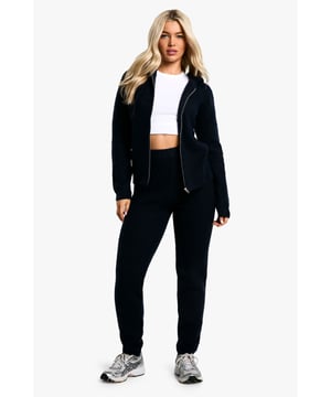 Soft fine knit fabric for ultimate comfort
        Hooded top with full-length zip closure
        Coordinating trousers for a complete look
        Versatile two-piece set for effortless styling
        Relaxed fit perfect for lounging or casual outings
    
    Embrace laid-back chic with this soft fine knit tracksuit. The hooded top with a full-length zip offers both style and practicality, while the coordinating trousers complete the ensemble. Perfect for those lazy Sundays or running errands, this set radiates comfort without compromising on trend. Style it with trendy trainers and a baseball cap for a street-smart look, or throw on some statement jewellery to dress it up for a casual coffee date. The versatility of this co-ord allows for endless styling possibilities - layer with a puffer jacket for cooler days or wear the pieces separately to mix and match with your existing wardrobe. Whether you're heading to the gym, meeting friends for a casual brunch, or simply lounging at home, this tracksuit is your go-to for effortless, comfortable style.
