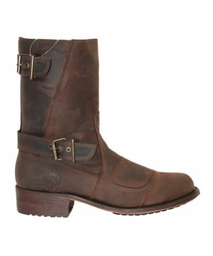 This cowboy style boot appears with a pointed toe, as well as a zip closure with buckles above the heel and at the start of the boot leg for secure fastening. This boot was manufactured with a Grinders proprietary sole unit, that has been heat bonded to the welt using the Goodyear method, which is known for increasing the strength of the boot and ensuring durability for years to come. The sole is also fitted with a unique air cushion that allows for added flexibility and which adds to the long-lasting qualities of this boot. Complete with a comfortable leather interior and exterior this high leg boot is a great piece for adding a stylish touch to your footwear. • Goodyear Welted • High leg silhouette with zip closure • Features stacked heels • Leather upper • Soft Leather lining • Rubber/Leather Soles • Made in Mexico