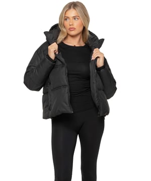 Stay warm and stylish with this Hooded Puffer Jacket. Designed with a high neck, long sleeves, and ribbed trims, it offers both comfort and protection from the elements. The jacket features a  zip-up front for a sleek look. Front welt pockets provide practical storage, while the ribbed hem and elasticated hood with an adjustable drawstring ensure a secure fit. The hem also includes an adjustable toggle for added flexibility.