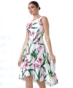Floral Satin Feel Dipped Hem Midi Dress from Roman. Embody glamour at your next special occasion with this luxurious Ariella dress! Featuring a classic round neckline and sleeveless silhouette, this flattering midi dress is ideal for the upcoming Wedding season. It boasts a feminine fit and flare shape with a floaty dipped hemline. Cut from a luxurious satin-look woven fabric, it is adorned in a seasonal floral print to give your occasionwear a fresh feel. Add strappy heels and a clutch bag for a day at the races!
