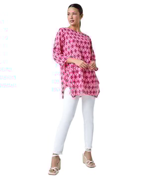Cotton Geometric Pocket Longline Tunic Top from Roman. Get set for Summer with this geometric print longline top. The tunic shape offers a flattering and relaxed fit, with pocket details adding a touch of practicality. Designed with a round neckline and 3/4 length tab sleeves, this airy cotton top features an asymmetrical hanky hem for added interest. The perfect Summer staple, style it with sandals and cropped trousers for a casual yet chic outfit on those sunny days!