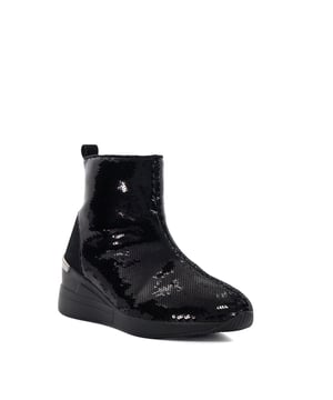 Make a style statement in Effecting, an ankle boot with a twist. Designed with a dazzling sequin finish and a chic chunky wedge heel, this design is perfect for adding glamour and flair to any ensemble, whether you're hitting the town or elevating your everyday look.