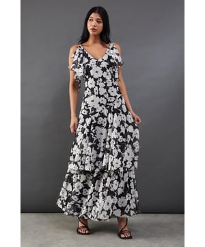 Strappy chiffon midi dress with bold floral print
        Layered tendril design for added movement and dimension
        V-neckline with delicate spaghetti straps
        Cold-shoulder detail with fluttery sleeves
        Tiered skirt with asymmetrical hemline for a dramatic silhouette
    
    Make a statement at your next night out with this captivating floral chiffon midi dress. The striking print and layered tendril design create a mesmerising effect as you move, ensuring all eyes are on you. The strappy neckline and cold-shoulder detail add a touch of allure, while the tiered skirt with its asymmetrical hemline offers a contemporary twist on a classic silhouette. Perfect for cocktail parties or dancing the night away, this dress pairs beautifully with strappy heels and statement earrings. For a more relaxed look, throw on a leather jacket and ankle boots. The versatile design allows for endless styling options, making it a go-to piece for various occasions. Whether you're heading to a rooftop bar or a trendy restaurant, this dress will help you radiate confidence and style.