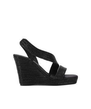 The Carvela Gala Wedge features a high wedge heel in an espadrille style. The upper straps also feature black crystal embellishment which curve across the foot. Heel height: 110mm.
