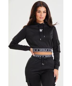 inchBlack Cropped Cargo HoodieSlim crop fitSoft touch fabricBranded jacquard elastic tapeEmbroidered logoCargo pockets on sleevesDrawcord hoodMachine wash95% Polyester 5% ElastaneModel 5ft 10in and wears a size Small inch