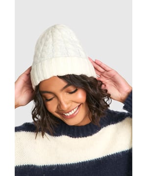 Ribbed texture for added warmth and style
        Cable knit pattern for a classic, timeless look
        Snug fit to keep ears protected from the cold
        Versatile design suitable for various casual outfits
        Soft and stretchy material for comfort
    
    Embrace the chilly weather with this charming ribbed cable knit beanie. Perfect for those crisp autumn days or frosty winter mornings, this hat offers both style and practicality. The intricate cable knit pattern adds a touch of traditional charm, while the ribbed texture ensures a snug fit that keeps you cosy. Pair it with your favourite jumper and jeans for a laid-back weekend look, or throw it on with a casual coat for impromptu coffee runs. Its versatility makes it an ideal accessory for family gatherings, outdoor markets, or casual meetups with friends. The beanie's design allows for easy styling with various hairstyles, whether you're sporting loose waves or a messy bun. Add this essential piece to your wardrobe and stay fashionably warm throughout the cooler seasons.