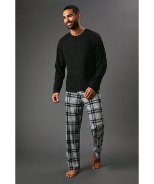 Cosy jersey top with long sleeves for ultimate comfort
        Stylish microfleece check trousers for a trendy look
        Versatile two-piece set perfect for lounging at home
        Relaxed fit design allows for easy movement
        Crew neck top pairs seamlessly with the patterned bottoms
    
    Embrace laid-back luxury with this Maine jersey top and microfleece check trousers set. The long-sleeved top offers a classic crew neck design, ideal for those chilly evenings at home. Paired with the eye-catching check trousers, this set strikes the perfect balance between comfort and style. Whether you're settling in for a movie night or enjoying a lazy weekend morning, this ensemble has got you covered. The relaxed fit of both pieces ensures unrestricted movement, while the contrasting solid top and patterned bottoms create a visually appealing look. For a quick dash to the corner shop, simply throw on a pair of trainers and a light jacket. This versatile set is a must-have addition to your loungewear collection, promising both cosiness and a touch of sophistication for your downtime wardrobe.