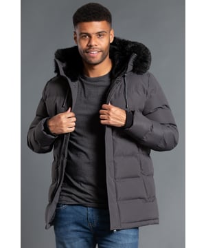 This longline hooded padded jacket from Nines by Kensington Eastside will ensure you are kept warm on colder days. Features faux fur hood with toggles and inside fur lining, zip and popper fastening, two large zip fastening pockets with divider, and ribbed elasticated cuffs for extra comfort.