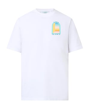 The T-shirt features a classic cut with a round neckline, offering a timeless silhouette. The front is graced with a vibrant, stylised print depicting an abstract representation of a window or gateway, bathed in the soft pastel hues of blue, yellow, and orange, evoking the serene beauty of a sunset. 