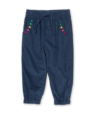 100% organic cotton | Proud to be certified by Control Union to the Global Organic Textile Standard (GOTS) | Navy blue corduroy | Heart embroidery detail at pockets | Side pockets and back patch pockets | Elasticated waistband with adjustable ties | Elasticated cuffs | Made in India | Machine washable at 40 degrees, or at 30 degrees to be kinder to the planet