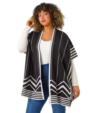 Curve Stripe Hem Square Poncho from Roman. Wrap up in style this Autumn with this our Curve stripe print poncho. Featuring an edge to edge opening and a beautiful border print detail, this versatile cardigan is perfect for adding a touch of sophistication to any outfit. Cut from a soft knit fabric finishing below hip length with trendy 3/4 sleeves, this square-shaped poncho is both cosy and stylish. Simply layer over a classic t-shirt and jeans for a casual yet put-together look!