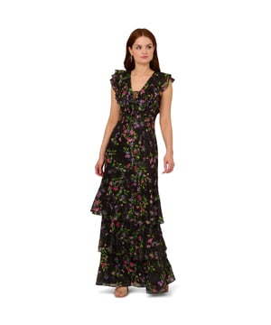 Bohemian details make this tiered gown an unforgettable look. This formal dress features a fitted bodice with v-neckline, flutter sleeves, and a tiered mermaid skirt. Designed from a multicolour floral chiffon fabric with embroidered lace details, this mermaid gown has a self-tie neckline for a modern contrast to the otherwise romantic look. A hidden zipper closure at the centre back completes this floral chiffon gown. Paired with nude or metallic heels and simple accessories, this ruffle-trimmed gown is a chic look for formal events and black-tie weddings.
