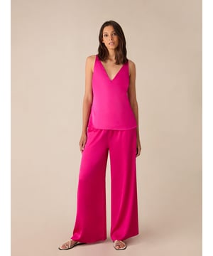 Co-founders' Notes

Our Pink Satin Wide Leg Trousers are crafted from lightweight hammered satin for a luxurious feel. These unlined trousers feature an elasticated ribbed waistband for comfort and a floaty silhouette for effortless style. Pair them with the matching top for a coordinated and chic look.

Unlined
Elasticated waist
Wide leg fit
Classic, standard fit. Try your usual size  



 Fabric &amp; Care



 Composition:   Main: 100% Polyester


 Garment Care:   Machine Washable



  Size &amp; Fit


Classic, standard fit. Try your usual size  

Inside leg length: 56cm (size 10) 

Model is 170 cm/5'7" and is wearing a size 10