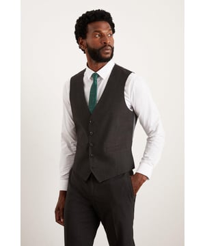 Introducing our Essential Tailored Fit waistcoat, the perfect addition to your smart wardrobe. The 5 button fastening and adjustable back strap ensures a perfect fit, making it suitable for any occasion. Made with a polyester viscose blend fabric with added stretch ensures a cool and comfortable fit all day long. Pair with matching items perfect for any smart occasion.