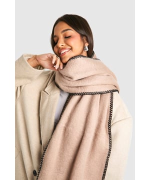 Knitted scarf with distinctive stitch detailing
        Contrasting edge stitching for a stylish finish
        Generous length for versatile styling options
        Soft, cosy texture for ultimate comfort
        Subtle fringe detailing at the ends for added flair
    
    Wrap yourself in effortless style with this chic knitted scarf from Boohoo. The eye-catching stitch detailing and contrasting edge stitching add a touch of sophistication to this casual accessory. Perfect for those chilly autumn days or crisp winter evenings, this scarf is your go-to companion for staying warm whilst looking fabulous. Drape it loosely over a leather jacket for an edgy look, or wrap it snugly around your neck with a cosy jumper for a more laid-back vibe. Its versatility makes it ideal for various casual occasions, from coffee dates with friends to family gatherings. The generous length allows for multiple styling options, so you can customise your look to suit your mood. Whether you're heading to the shops or enjoying a weekend stroll in the park, this scarf will keep you looking trendy and feeling snug.