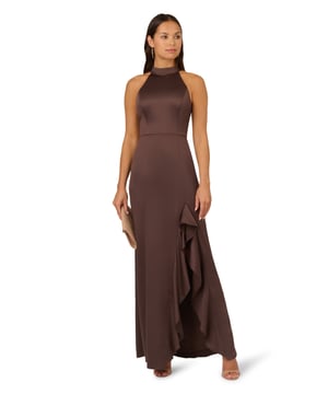 Fall for dreamy fabric and details when you select this satin mermaid gown for your next occasion. This formal dress features a sleeveless halter bodice, mock neckline, and a mermaid skirt with a slit trimmed with ruffles. Designed with satin fabric, the bodice of this formal dress has princess seams for a fit that flatters your figure. A self-tie neck adorns the cutout back and a hidden zipper closure at the centre back completes this evening gown. Paired with statement jewellery and metallic heels, this sleeveless satin gown will shine for formal and black-tie events.