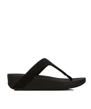 Dames Fit Flop Lottie Glitzy Toe Thong Sandalen in zwart.- Bovenwerk van textiel.- Slip on sluiting.- Naadloze ingebouwde boogcontour.- Glinsterende stof. - Biomechanisch ontworpen.- Microwobbleboard Standard-technologie.- Slipbestendige rubberen buitenzool.- Ref.: R24001