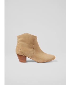 Embrace the wild west with a modern spin in the Leida ankle boots. Crafted from textured suede in tan, these boots are lined with leather, feature a classic round toe, and a sturdy block heel. Designed in Spain with sustainability in mind, they blend cowboy aesthetics with versatility. Pair them with denim or a flowy dress for varied styles.