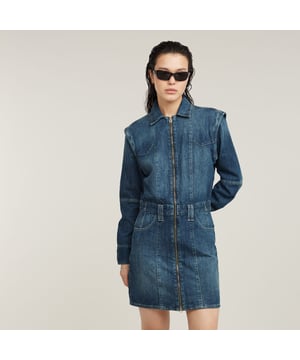 Shirt collar. Zipper closure. Concealed zippers at the shoulder to detach long sleeve. Inset pockets. Belt loops. Zip closure. Denim dress Biker offers an upper leg length and is designed as a modular style. Unzip the sleeves to change this long sleeved dress into a sleeveless dress. When preferred a belt can be added to the beltloops applied. 80% Cotton, 20% Recycled cotton. Rigid. Slim