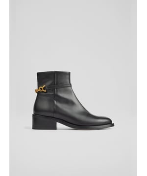 A chunky but refined ankle boot in glossy leather, the new Lola boots are that wearable, everyday style you'll just zip-up and go. Crafted in Spain from black patent leather, they have a round toe, matte gold snaffle detail to the ankle, an inside zip and a black stacked square heel. Designed to wear with jeans, tailoring, dresses - they do it all.