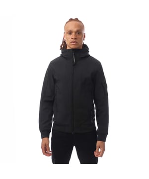 Mens C.P. Company Shell-R Hooded Jacket in black.- Adjustable hood.- Full two-way zip fastening.- Lens detail.- Zipped front pockets.- Ribbed cuffs and hem.- Regular fit.- 94% Polyester  6% Elastane.- Ref: 17CMOW013A999