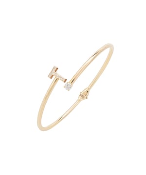 Design:This simple but beautifully styled initial bangle bracelet is perfect for those who covet delicate jewellery with a hint of sparkle, offering a sophisticated finishing touch to any outfit.Pretty and petite, this initial open cuff bangle features a hinge on the underside which makes it easy to put on and take off. The opening is designed to be on top of the wrist, where a zircon adorned monogram sits on one side and a single larger cubic zirconia resides on the other.What can be more personal than a name? Give this initial bangle bracelet as the perfect personalised birthday gift. Materials:Handcrafted using 925 sterling silver, dipped in 22ct gold. White cubic zirconia.Style Notes:Perfect pairing to the initial ring.Personalised birthday gift ideas. Bridesmaid gifts. Simple everyday styling.Dimensions:Bracelet: 19.5cm Packaging:This item is presented in a Latelita London signature jewellery box.Care Instructions:To maintain your jewellery, wipe gently with a damp cloth that is soft and clean. Do not soak in water. Avoid contact with soaps, detergents, perfume or hair spray.