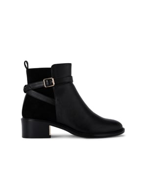 This KG Kurt Geiger Helen ankle boot features a black upper with a microsuede panel on the heel. There is a strap around the ankle with a gold tone buckle.