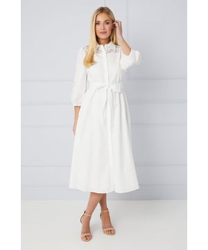 This elegant white shirt dress is crafted from a comfortable cotton blend fabric, making it a versitile style to wear to any occasion. The delicate lace trim adds a touch of femininity to the classic design, and it can be dresses up or down. If you're attending the races, going to a garden party, or looking for something to wear on holiday, this dress is easy to dress up or down with a pair of heels or sandals.
